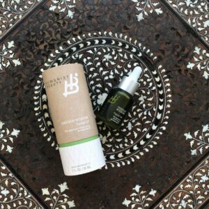 Elevate your skincare routine with Herban Wisdom Facial Oil beautifully displayed on an intricate ornate tile.