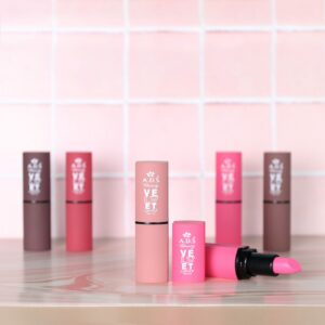 A vibrant display of pink and brown lipsticks on a pastel grid background.