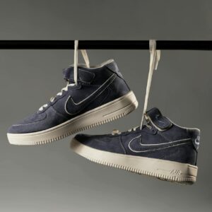 High top sneakers hanging by laces, perfect for product display.
